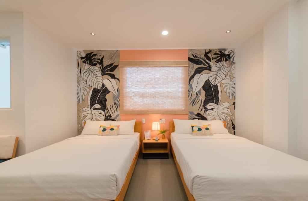 Postel nebo postele na pokoji v ubytování Shoho Hotel Nha Trang