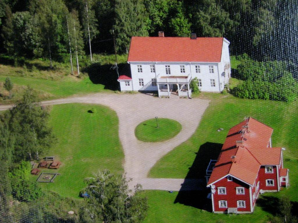 an aerial view of a large white house with a red roof at Farmhouse with facilities in the middle of nature in Sysslebäck
