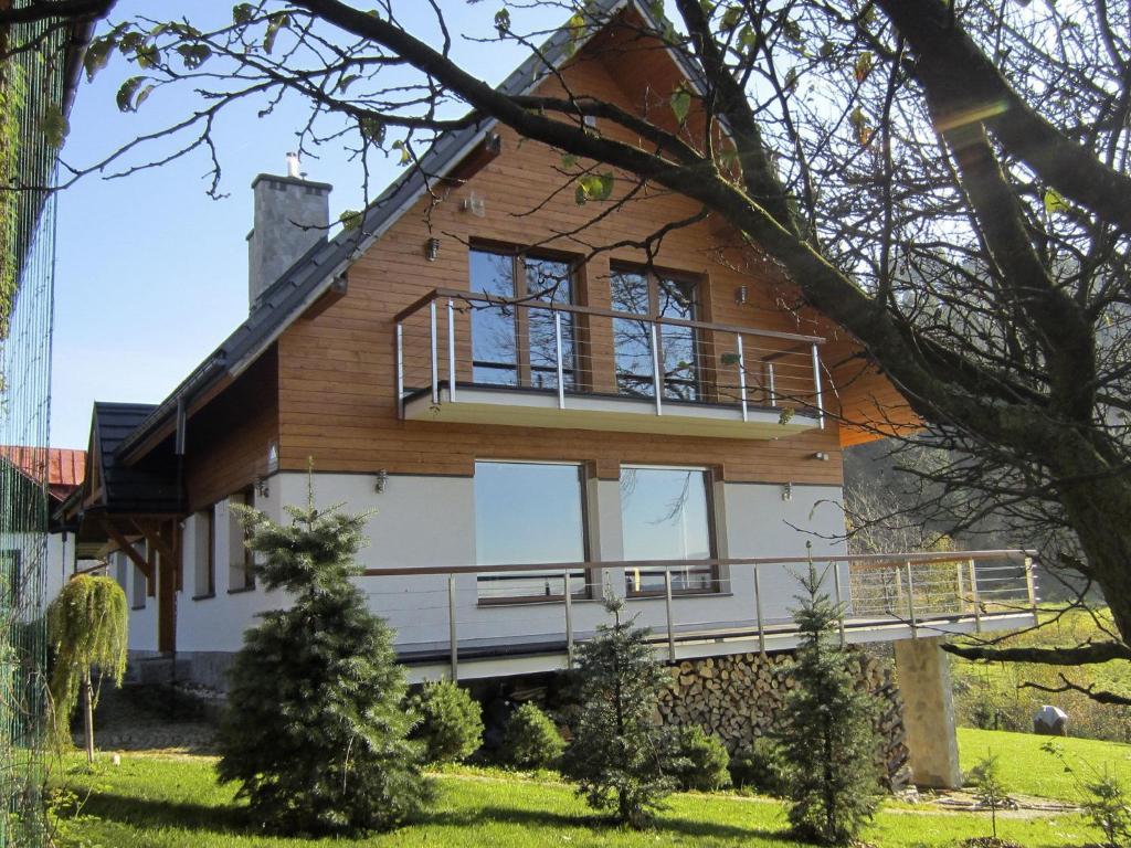 a house with a balcony on the side of it at Modern Villa in Zwardon with Sauna in Zwardoń