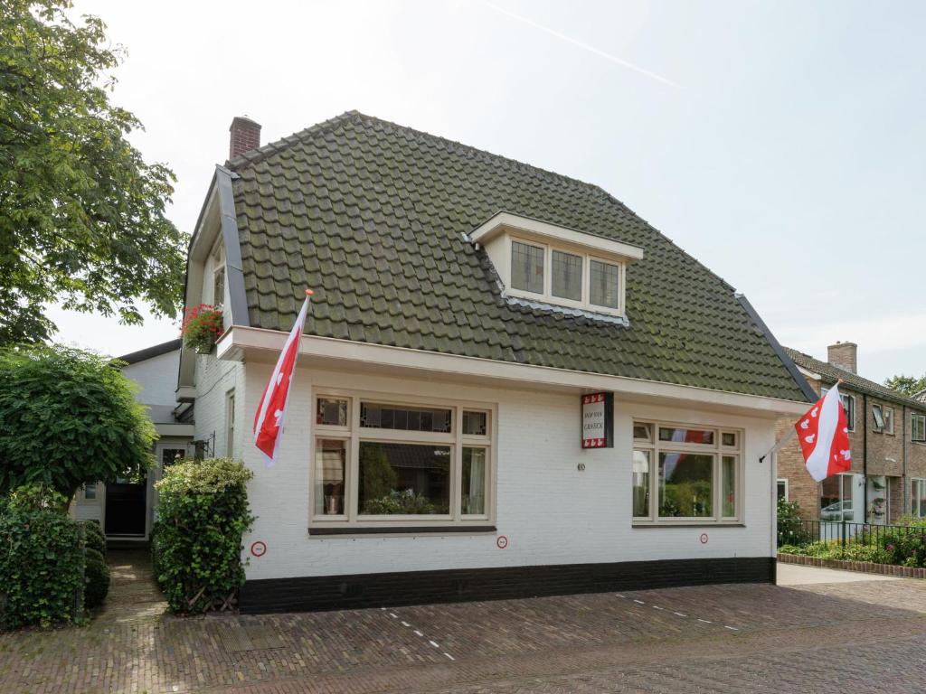 a white house with flags in front of it at Attractive Apartment in Bergen with Garden in Bergen