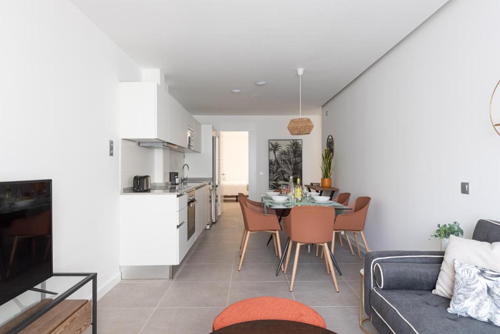 a living room and kitchen with a table and chairs at Royal Flats in Las Palmas de Gran Canaria