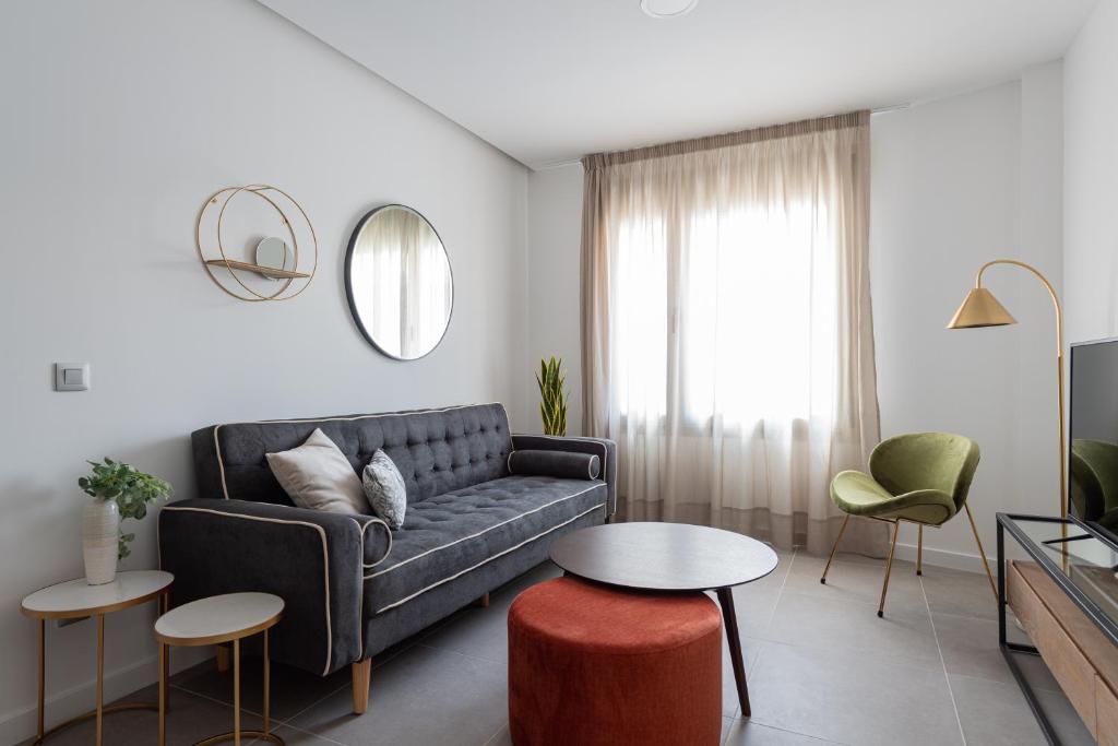 a living room with a couch and a table at Royal Flats in Las Palmas de Gran Canaria