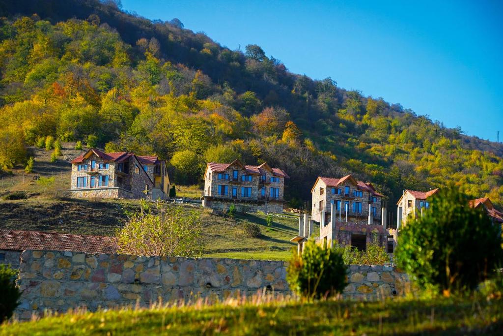 a group of houses on a hill with a mountain at Apaga Resort in Ijevan