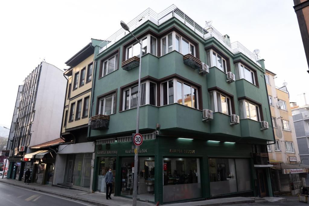 a green building on the corner of a street at GREEN SUITES BURSA in Bursa