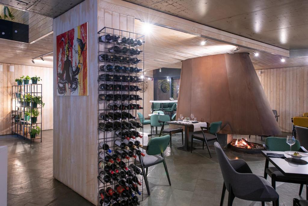 a room with a wall filled with wine bottles at Pensiunea Atra Doftana in Teşila