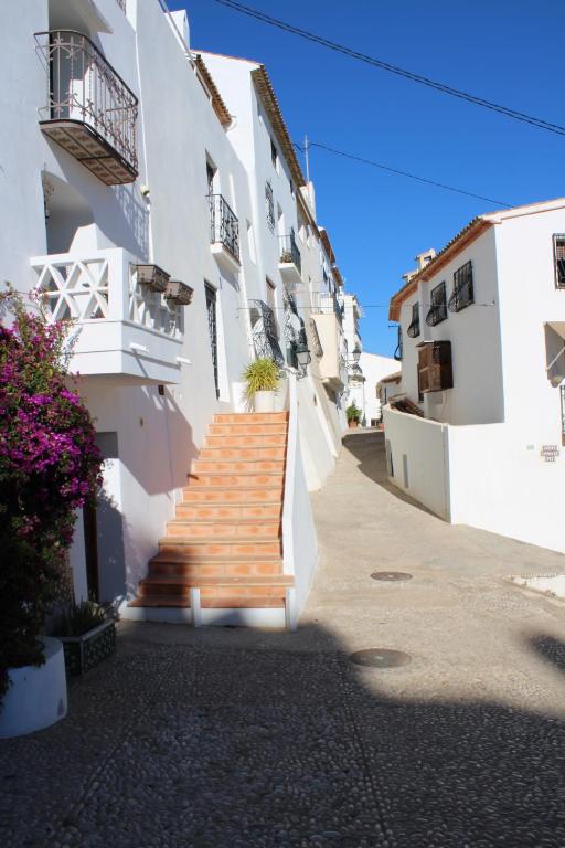 a stairway leading up to a building with white walls at Hostal Fornet Altea in Altea