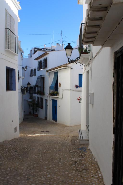 an alley in a town with white buildings at Hostal Fornet Altea in Altea