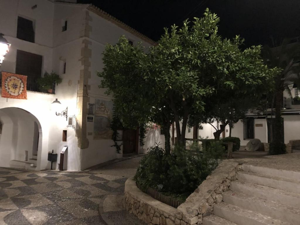 a building with stairs and trees in front of it at Hostal Fornet Altea in Altea