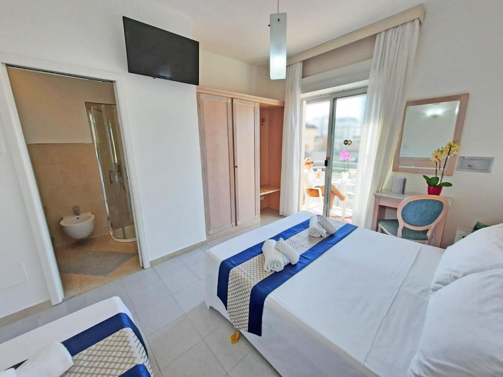 Postel nebo postele na pokoji v ubytování Hotel Margherita