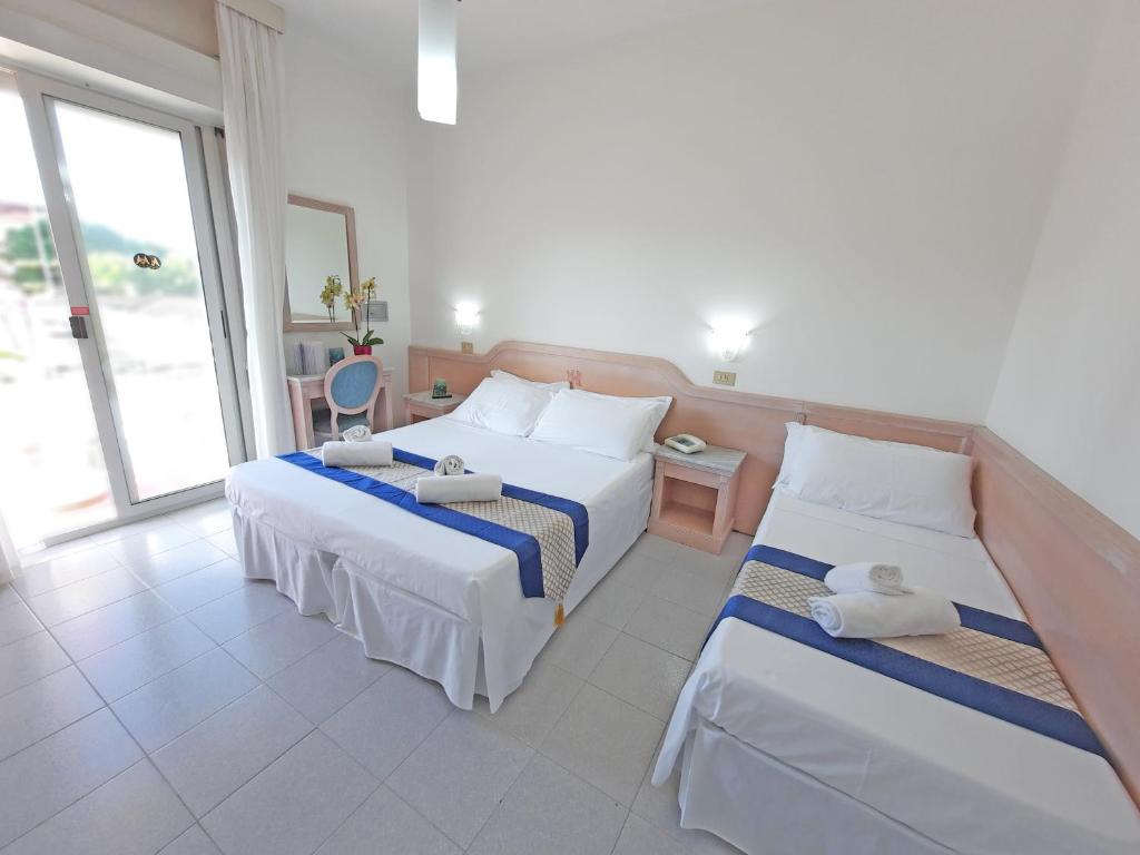 Postel nebo postele na pokoji v ubytování Hotel Margherita