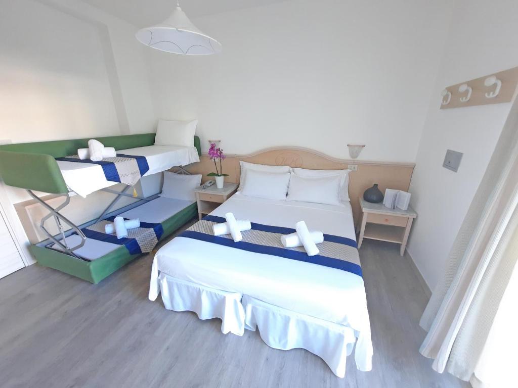 Postel nebo postele na pokoji v ubytování Hotel Margherita