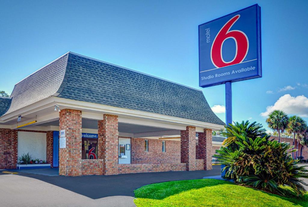 a gas station with a sign in front of it at Motel 6-Tallahassee, FL - Downtown in Tallahassee