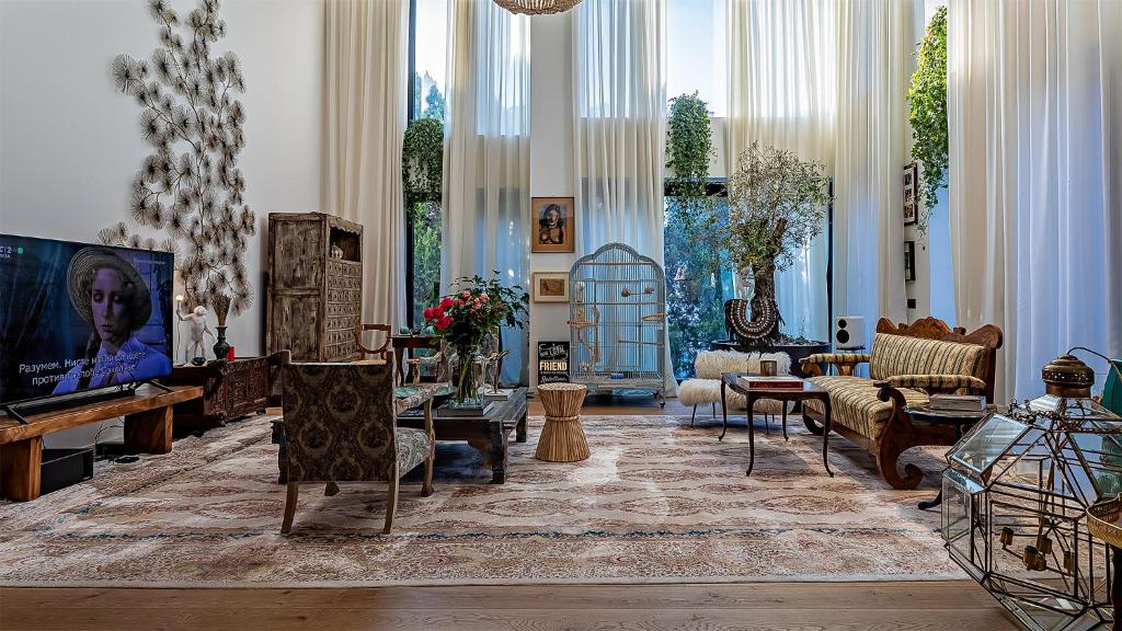 a living room filled with furniture and a tv at The Babe Boutique Hotel in Belgrade