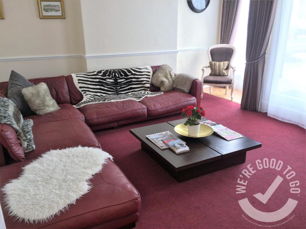 Devonshire House في باث: غرفة معيشة مع أريكة وطاولة قهوة