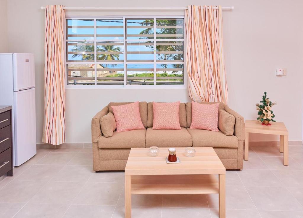 a living room with a couch and a table at Apartahotel MACADANA in Nagua