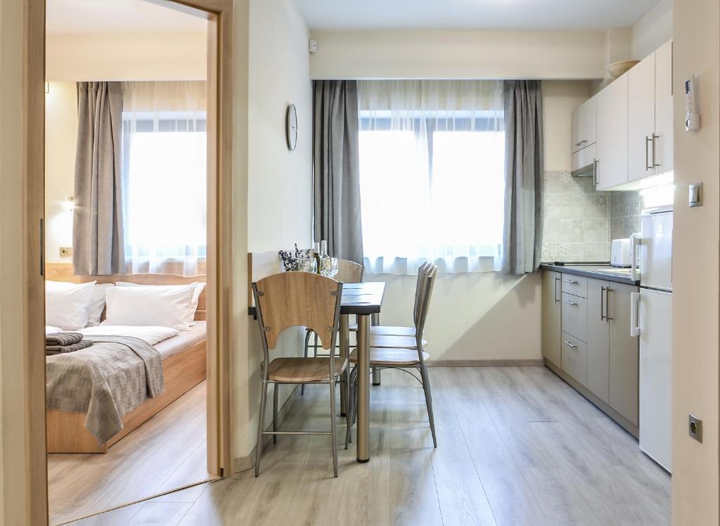 Schlafzimmer mit einem Bett, einem Tisch und Stühlen in der Unterkunft For You Apartmanok in Eger