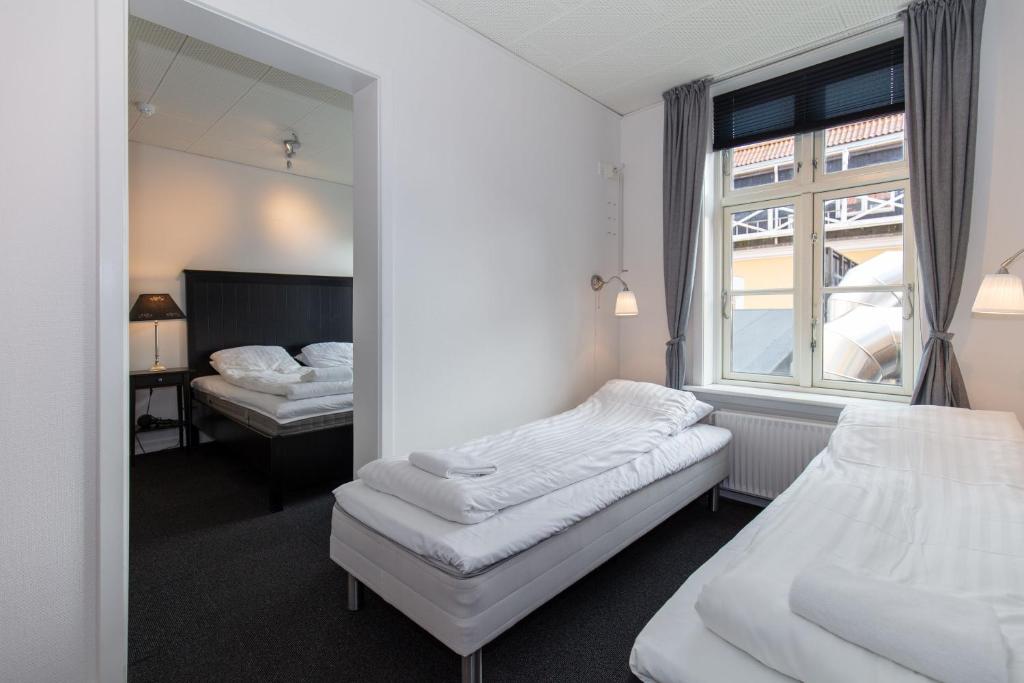 Postel nebo postele na pokoji v ubytování Skagen Hotel