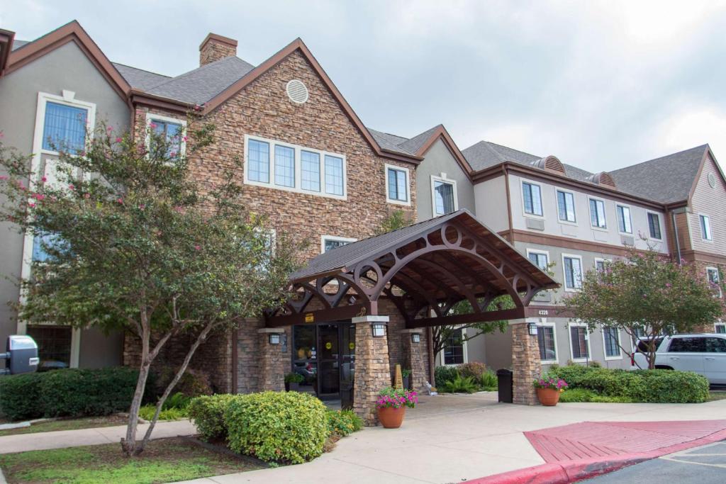 a large brick building with an archway in front of it at Sonesta ES Suites San Antonio Northwest Medical Center in San Antonio