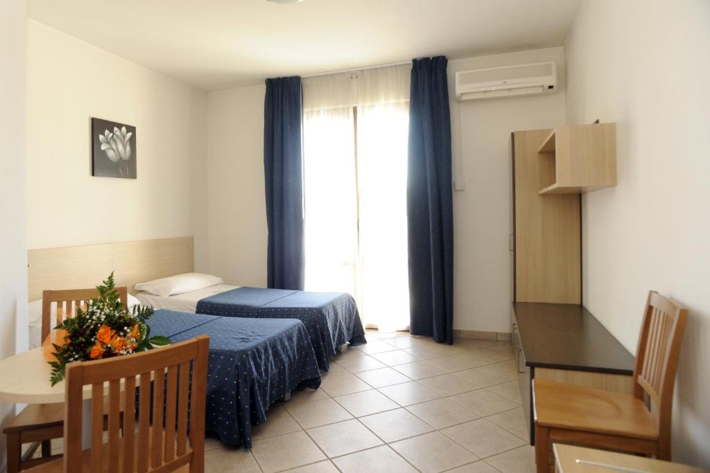 Postel nebo postele na pokoji v ubytování Hotel La Quercia