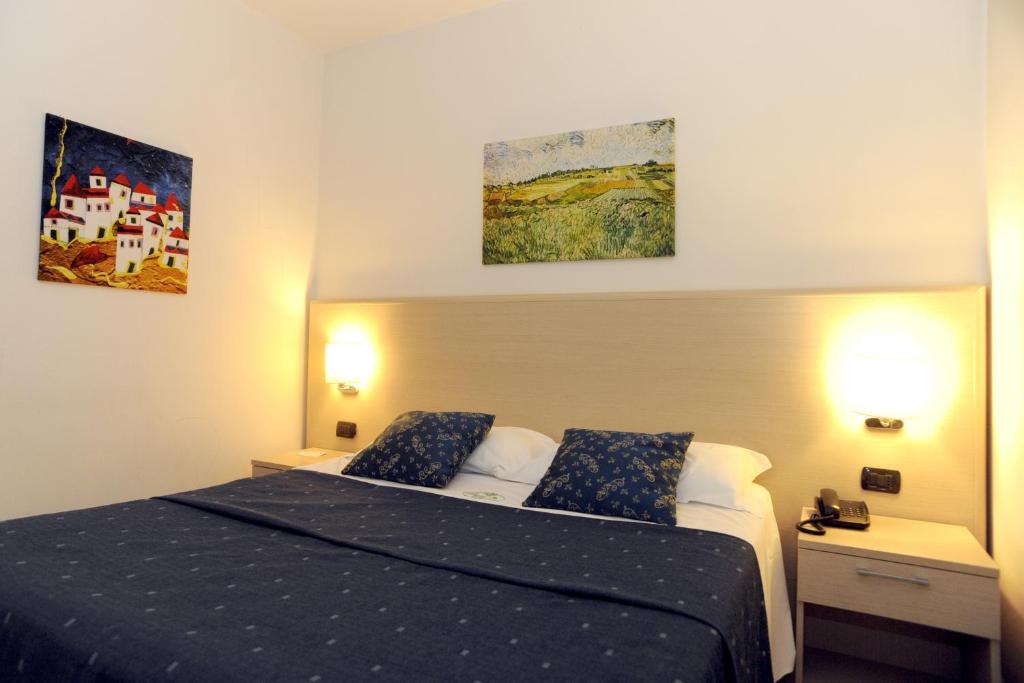 Postel nebo postele na pokoji v ubytování Hotel La Quercia