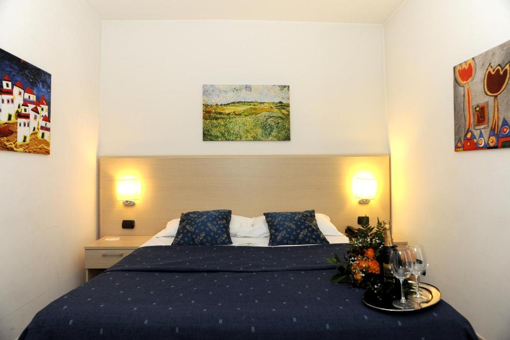 Postel nebo postele na pokoji v ubytování Hotel La Quercia
