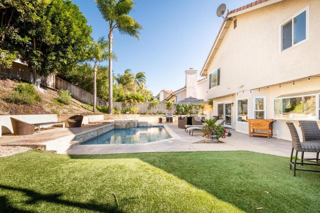 a backyard with a swimming pool and a house at Luxury San Diego House, Beach, Pool & Pet-Friendly in San Diego