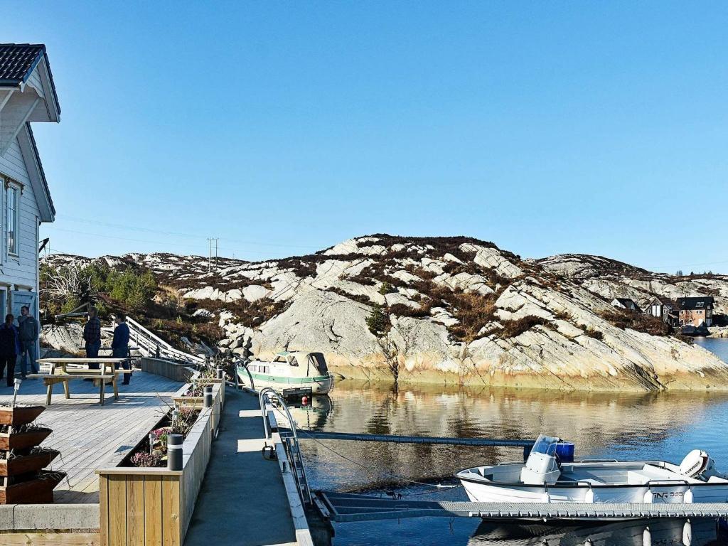 a dock with two boats in a body of water at Holiday Home Goddevegen in Ervik