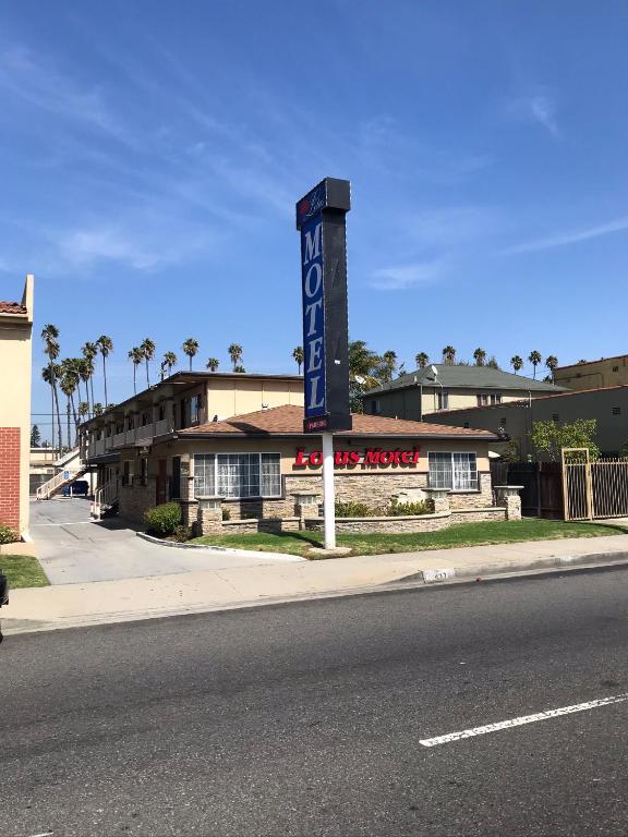 a sign for a hotel on the side of a street at Lotus Motel in Inglewood