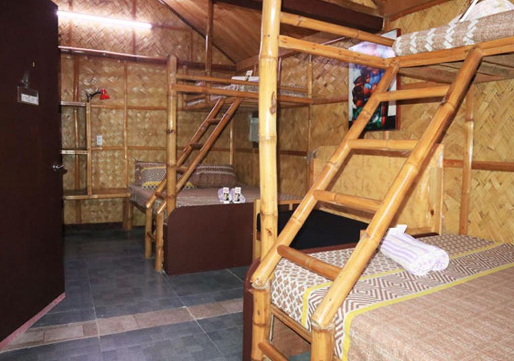 a room with three bunk beds in a building at Cool Martin Family Hotel and Resort in Bacoor