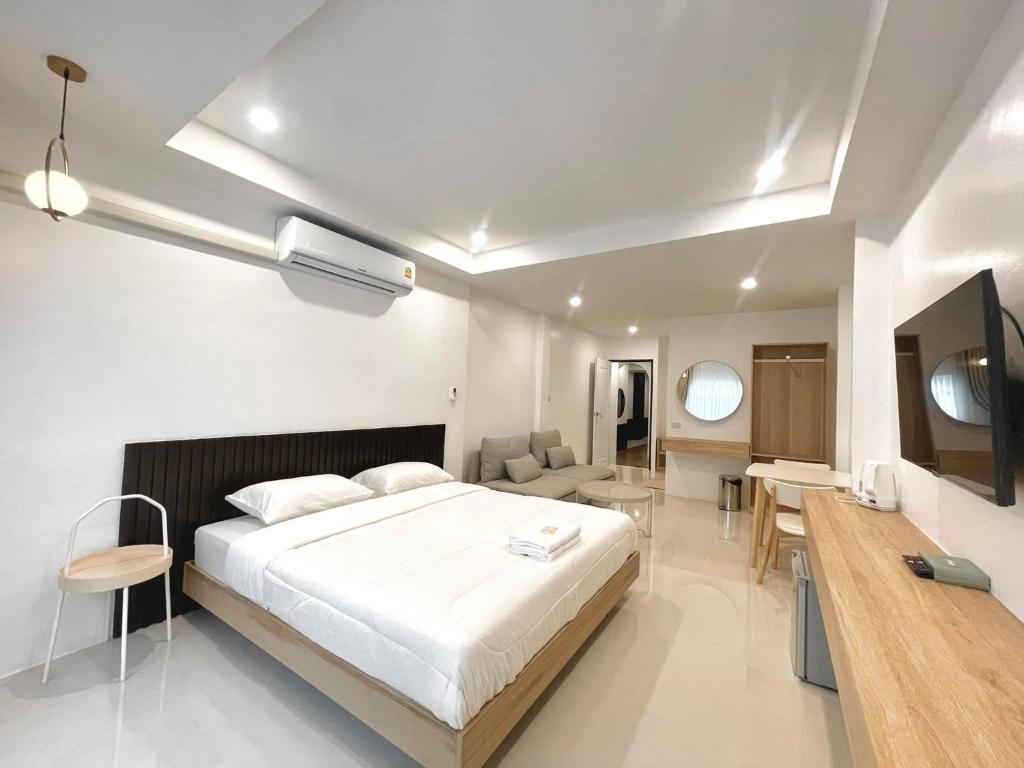 ein Schlafzimmer mit einem Bett und ein Wohnzimmer in der Unterkunft Topnorth Hotel Maesai in Mae Sai