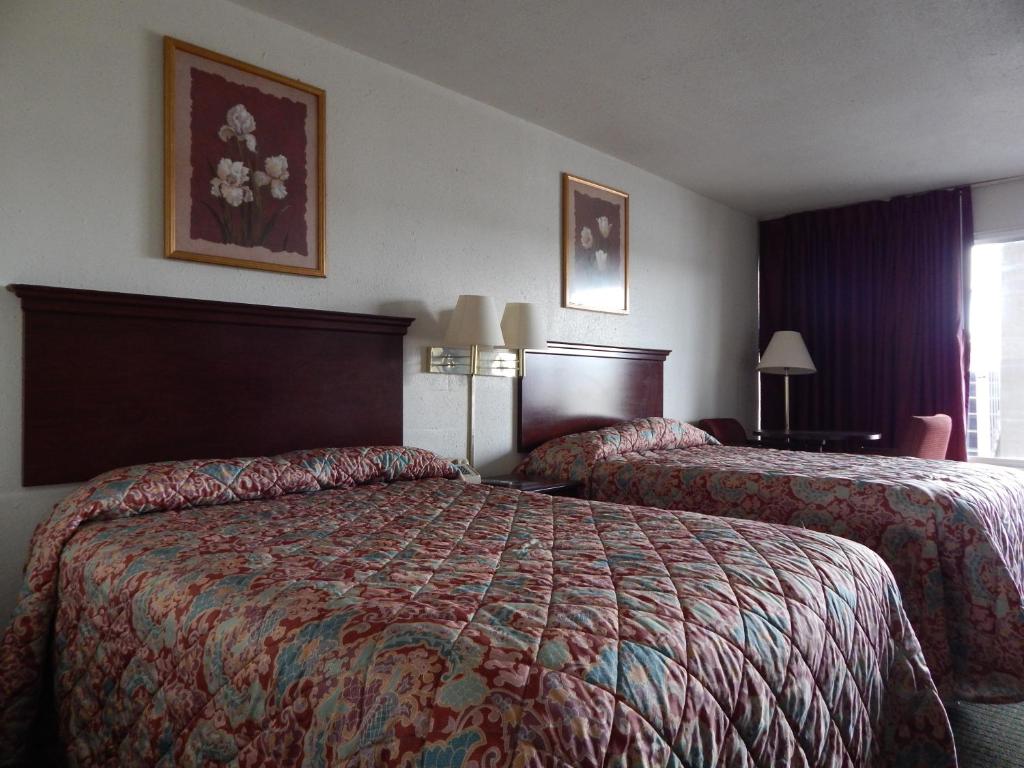 a hotel room with two beds and a window at Knights Inn - Plant City in Plant City