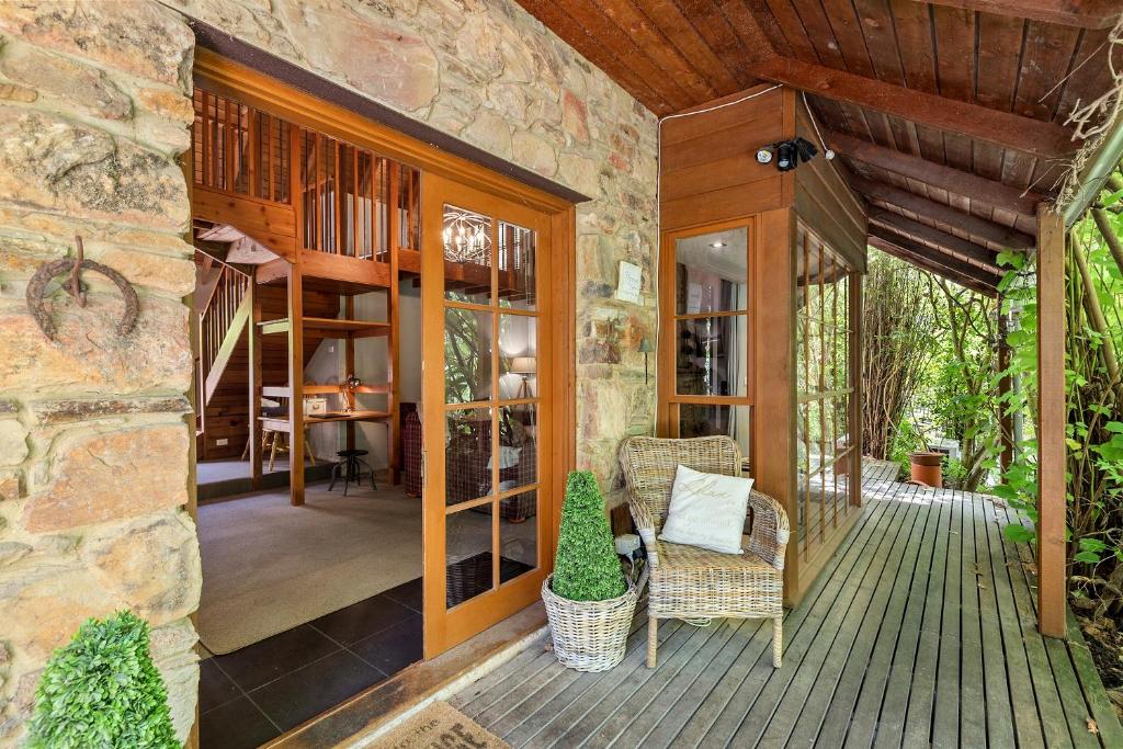 a porch of a stone house with a patio at Stonehenge Retreat in Ballarat