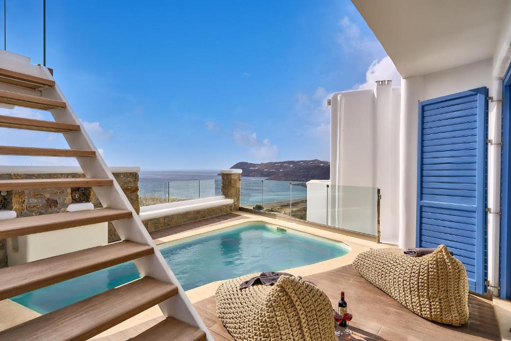 a house with a swimming pool and a ladder at Arte & Mare Elia Luxury Suites and Villas in Elia Beach