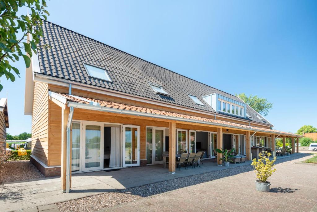 an exterior view of a house with sliding glass doors at Ride by the Sea Guesthouse in Koudekerke