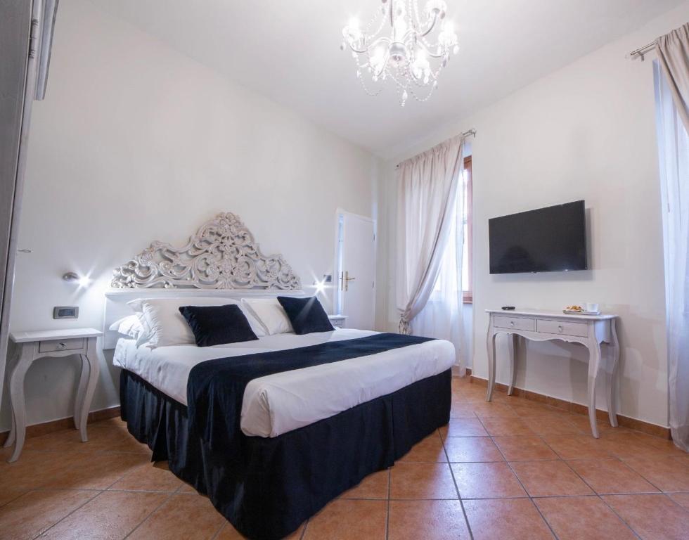 a bedroom with a large bed and a television at Residenza Florentia in Florence
