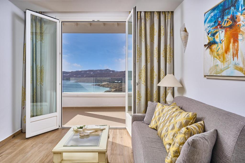 a living room with a couch and a view of the ocean at Arte & Mare Elia Luxury Suites and Villas in Elia Beach