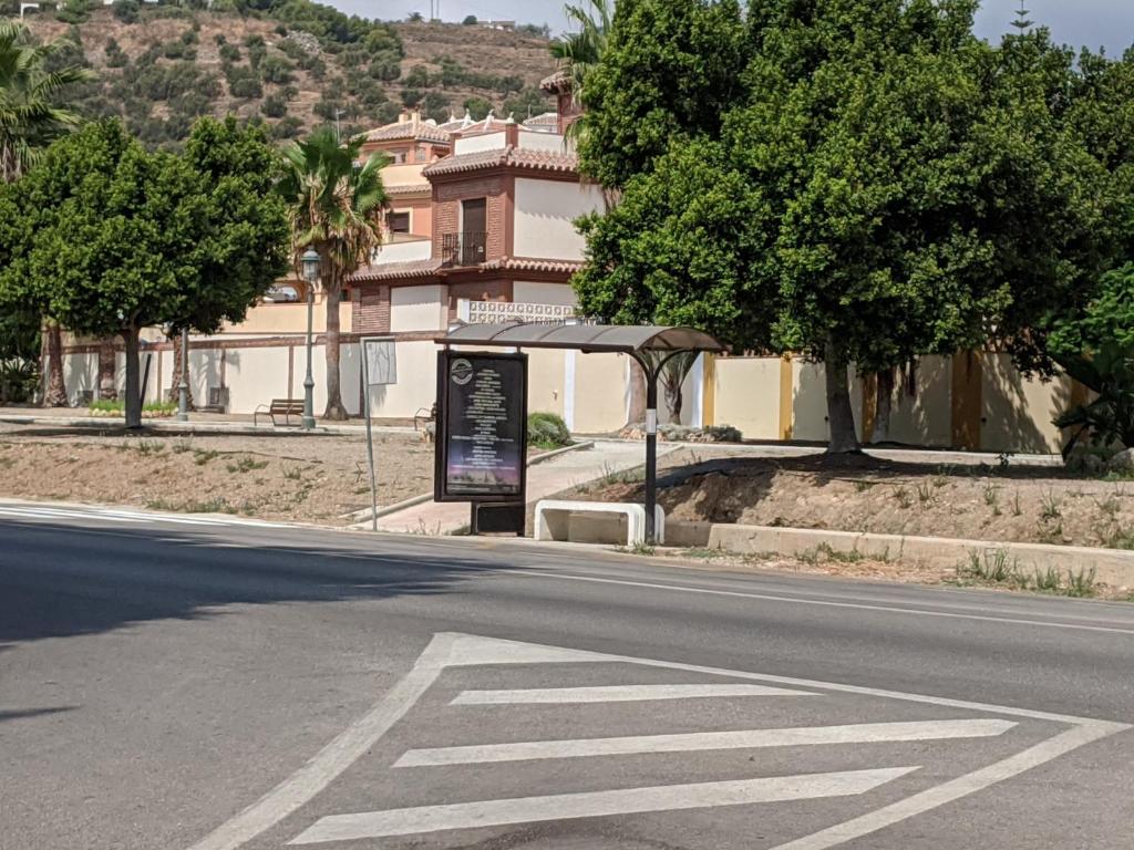 an empty street with a sign on the side of the road at Renovated apartment on beachside with pool in Nerja