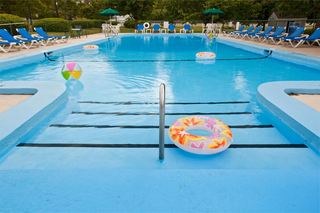 a swimming pool with a donut in the water at Ocean Park Inn Cape Cod in Eastham