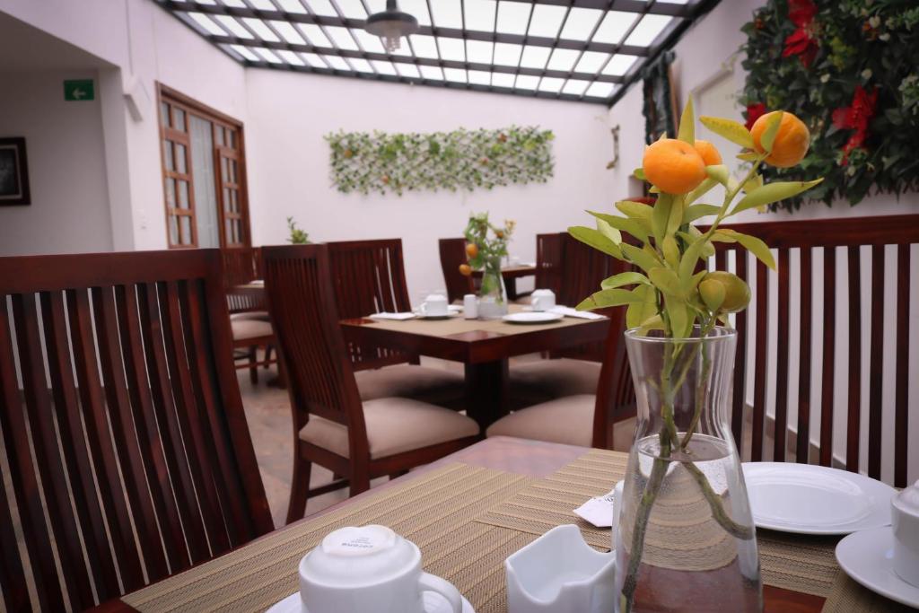a table with a vase with a flower in it at La Huerta Hotel Boutique in Tibasosa
