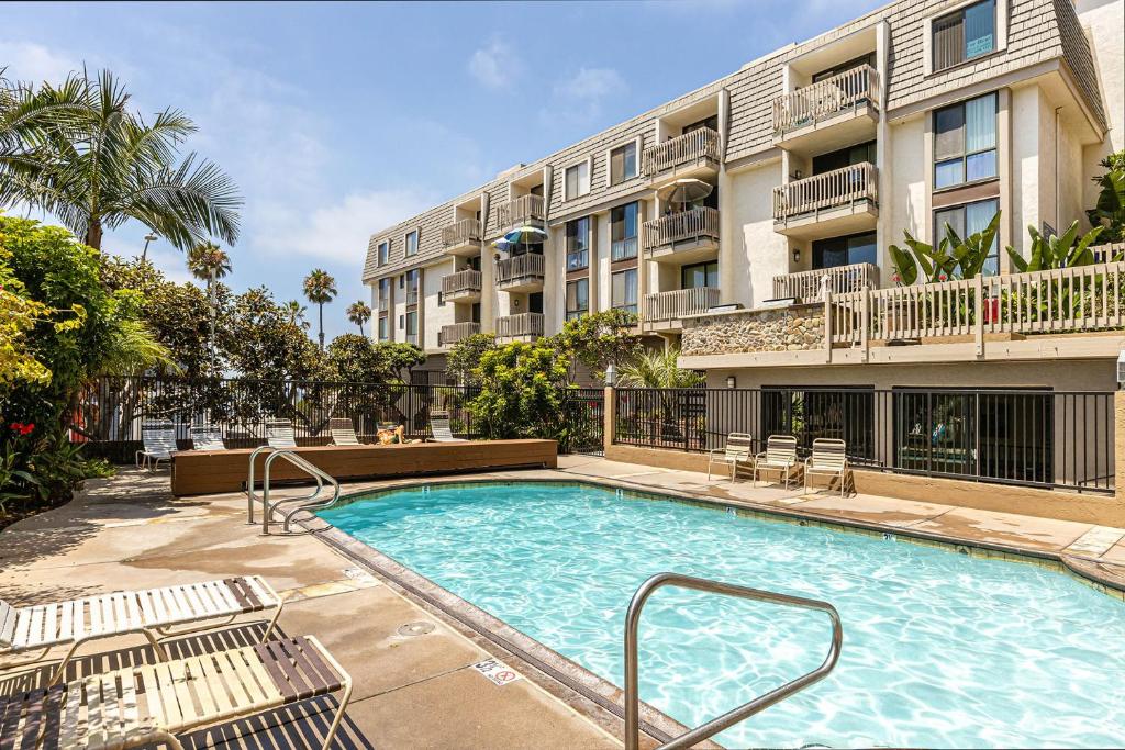 a swimming pool in front of a apartment building at Bargain Condo in Beach Resort A-206 in Oceanside