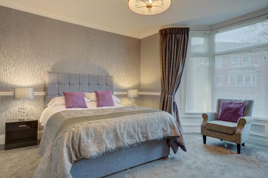 a bedroom with a bed and a chair and a window at Sunderland Self-Catering 1 -Chester Cottage in Sunderland