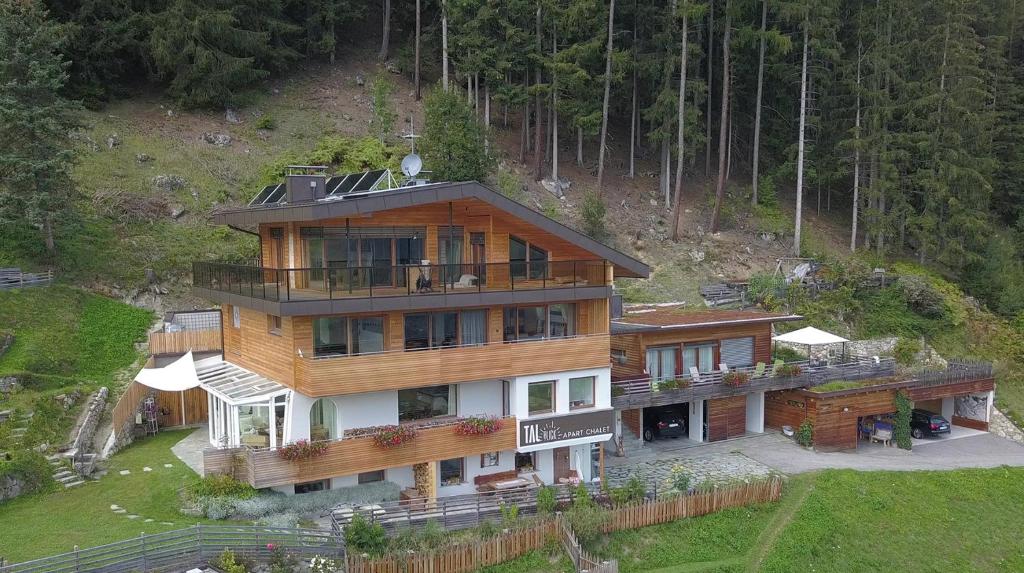 an aerial view of a house on a hill at Apart-Chalet Talblick in San Giovanni in Val Aurina