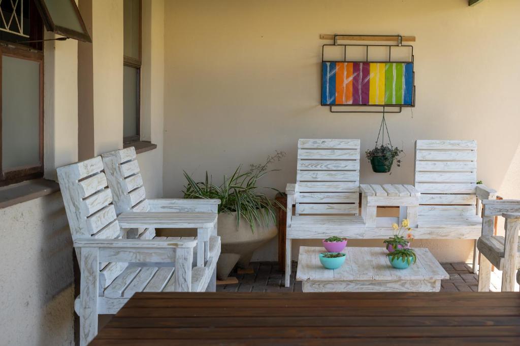 two chairs and a table on a patio at Selborne Bed and Breakfast in East London