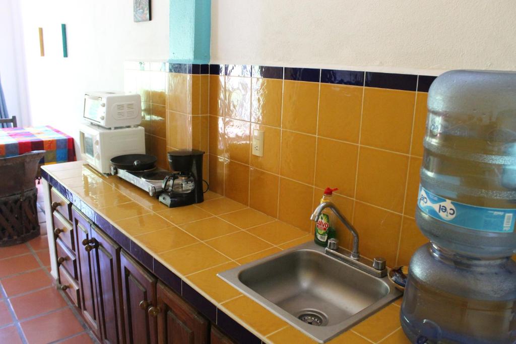 a kitchen with a sink and a counter top at La Posada Pacifica in Puerto Vallarta