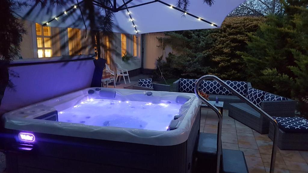 a jacuzzi tub on the patio of a house at Beáta Apartman in Gyula