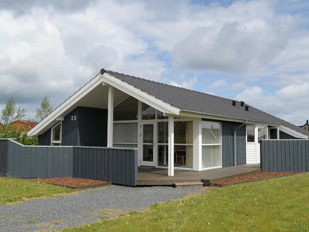 a house with a black and white at Three-Bedroom Holiday home in Otterup 4 in Otterup