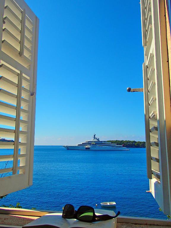 a cruise ship in the water with a large boat at Holiday Home Adriatic Pearl in Dubrovnik