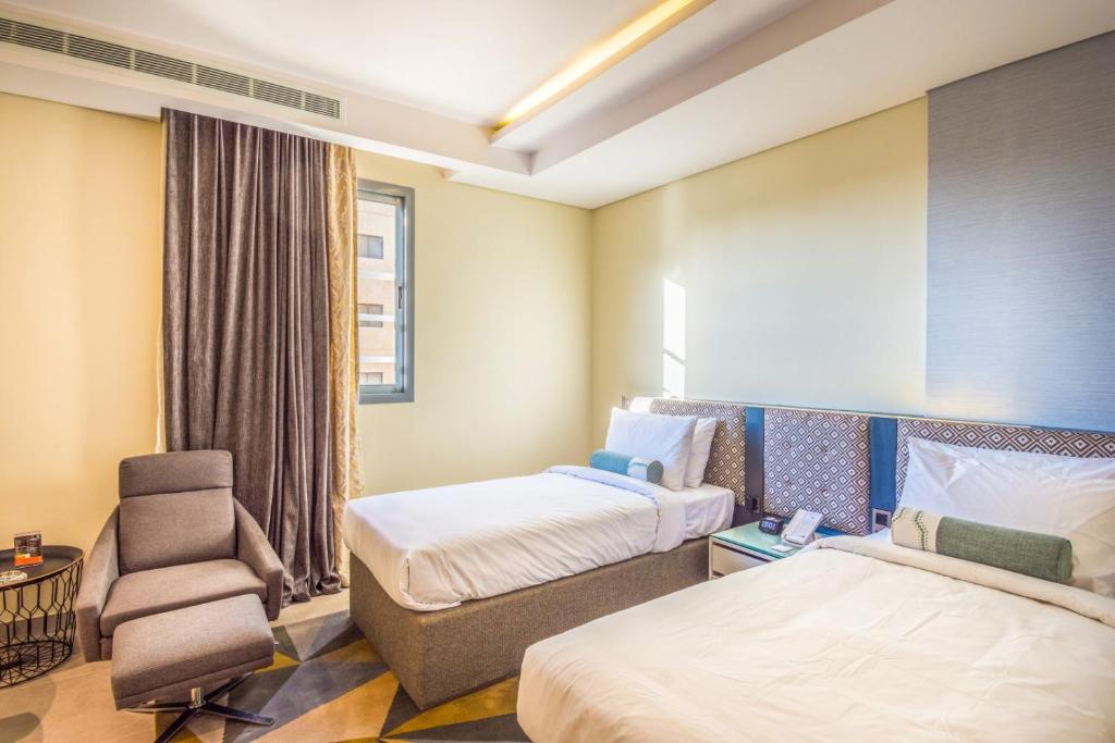 Postel nebo postele na pokoji v ubytování Ewaa Express Hotel - Tabuk