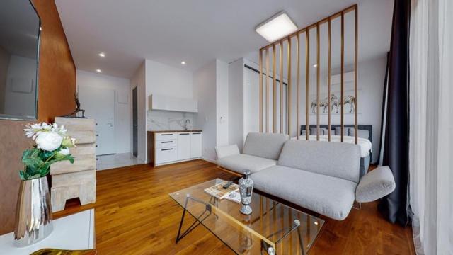 a living room with a couch and a table at Apartmán v srdci Tatier in Dolná Lehota