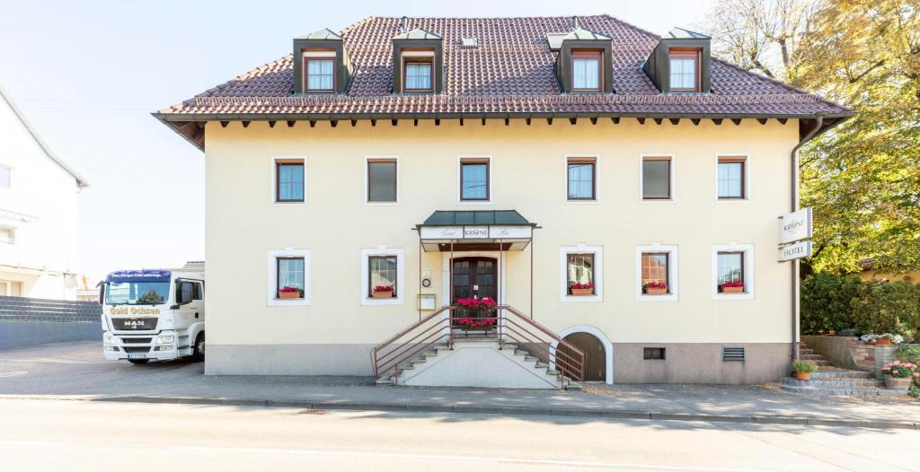 a large white house with a staircase in front of it at Hotel Krone Straßdorf in Schwäbisch Gmünd